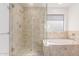 Walk in shower and separate tub feature tile surround with glass doors at 405 E Wescott Dr, Phoenix, AZ 85024