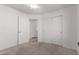 Neutral bedroom features carpet flooring, closet storage, and a hallway view at 405 E Wescott Dr, Phoenix, AZ 85024