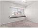 Bright bedroom features a cozy window seat and plush carpeting at 405 E Wescott Dr, Phoenix, AZ 85024