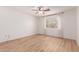 Bright bedroom features wood-look flooring, a ceiling fan, and a window with natural light at 405 E Wescott Dr, Phoenix, AZ 85024
