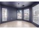 Dining room with neutral tile flooring, dark walls, many windows, and a modern pendant light fixture at 405 E Wescott Dr, Phoenix, AZ 85024