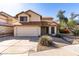 Charming two-story home with a two-car garage and desert landscaping under a bright blue sky at 405 E Wescott Dr, Phoenix, AZ 85024