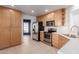 Well-lit kitchen featuring stainless steel appliances, tile flooring, and light wood cabinets at 405 E Wescott Dr, Phoenix, AZ 85024