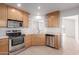 Bright kitchen with stainless steel appliances, light wood cabinets, and tile backsplash at 405 E Wescott Dr, Phoenix, AZ 85024