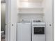 Functional laundry room closet with washer, dryer and shelving at 405 E Wescott Dr, Phoenix, AZ 85024