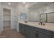 Modern bathroom featuring double sinks, gray cabinetry, and a glass-enclosed shower at 4050 W Nora Dr, San Tan Valley, AZ 85144