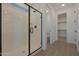 Bright bathroom boasts a glass-enclosed shower and a view into the walk-in closet at 4050 W Nora Dr, San Tan Valley, AZ 85144