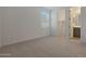 Bedroom with cozy carpet, a window with blinds, and doorways to a walk-in closet and bathroom at 4050 W Nora Dr, San Tan Valley, AZ 85144