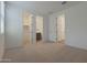 Carpeted bedroom features access to a walk-in closet and bathroom, enhancing convenience and privacy at 4050 W Nora Dr, San Tan Valley, AZ 85144