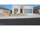 Contemporary home featuring desert landscaping, a gray garage door, and a light stucco exterior at 4050 W Nora Dr, San Tan Valley, AZ 85144