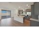 Open concept kitchen with gray cabinets, stainless appliances, island, and sliding glass doors at 4050 W Nora Dr, San Tan Valley, AZ 85144