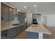 Well-equipped kitchen with gray cabinets, stainless steel appliances, and a center island at 4050 W Nora Dr, San Tan Valley, AZ 85144