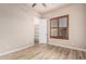 Bedroom featuring wood floors, a window with shutters, and a closet at 4318 N 180Th Dr, Goodyear, AZ 85395