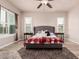 Spacious bedroom with a king-size bed, wood floors, large windows, and neutral walls at 4318 N 180Th Dr, Goodyear, AZ 85395
