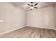 A bedroom features wood floors, neutral paint, and a ceiling fan at 4318 N 180Th Dr, Goodyear, AZ 85395