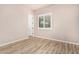 Bedroom with light-tone walls, wood-look flooring, and window with blinds at 4318 N 180Th Dr, Goodyear, AZ 85395