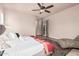 Bright and large bedroom with hardwood floors, ceiling fan, neutral walls, and chaise lounge chair at 4318 N 180Th Dr, Goodyear, AZ 85395