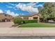 Well-maintained home with artificial turf lawn, mature landscaping and trimmed hedges at 4318 N 180Th Dr, Goodyear, AZ 85395