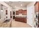 Kitchen boasts ample cabinets, granite counters, and stainless steel appliances at 4318 N 180Th Dr, Goodyear, AZ 85395