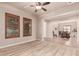 Spacious living room featuring wood floors, neutral paint and direct access to the dining area at 4318 N 180Th Dr, Goodyear, AZ 85395