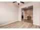 Living room boasts hard wood floors and decorative stack stone accent wall at 4318 N 180Th Dr, Goodyear, AZ 85395