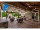 This covered outdoor space includes a ceiling fan and is perfect for entertaining at 4318 N 180Th Dr, Goodyear, AZ 85395