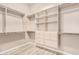 Walk-in closet featuring wood floors, shelving, and built in storage drawers at 4318 N 180Th Dr, Goodyear, AZ 85395