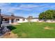 Expansive backyard featuring a lush green lawn, mature landscaping, and a classic exterior, perfect for outdoor activities at 4809 N 30Th Pl, Phoenix, AZ 85016