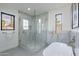 Bright bathroom features a glass shower and large tub under a window at 4809 N 30Th Pl, Phoenix, AZ 85016