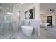 Bright bathroom features a glass shower, stand alone tub and view to the bedroom at 4809 N 30Th Pl, Phoenix, AZ 85016