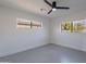 This bedroom is bathed in natural light, with a ceiling fan and two windows at 4809 N 30Th Pl, Phoenix, AZ 85016