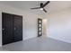 Bright bedroom featuring a spacious closet and a black ceiling fan at 4809 N 30Th Pl, Phoenix, AZ 85016