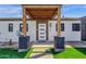Inviting front porch with wood beam features and modern accents at 4809 N 30Th Pl, Phoenix, AZ 85016