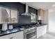 Contemporary kitchen featuring stainless steel appliances, a black accent wall, and natural light at 4809 N 30Th Pl, Phoenix, AZ 85016