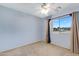 This bedroom is carpeted and features a window with curtains and a ceiling fan at 5236 N 16Th Ln, Phoenix, AZ 85015