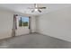Spacious bedroom with a carpeted floor, ceiling fan and window at 5236 N 16Th Ln, Phoenix, AZ 85015