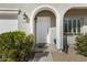 Inviting front entrance features a white door under an archway, complemented by manicured landscaping at 5236 N 16Th Ln, Phoenix, AZ 85015