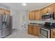 Open kitchen with stainless steel refrigerator and appliances with a view to powder room at 5236 N 16Th Ln, Phoenix, AZ 85015
