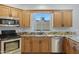 Close up of sink, stainless steel appliances, granite countertops and wooden cabinetry at 5236 N 16Th Ln, Phoenix, AZ 85015