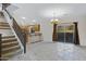 Open-concept living area featuring staircase access, neutral color palette, and sliding glass door at 5236 N 16Th Ln, Phoenix, AZ 85015