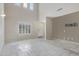 Bright living room with soaring ceilings, tiled floors, and large windows with plantation shutters at 5236 N 16Th Ln, Phoenix, AZ 85015