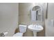 Powder room with white pedestal sink, decorative mirror and neutral colored walls at 5236 N 16Th Ln, Phoenix, AZ 85015