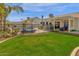 Backyard with a pool, privacy fence, tropical landscaping and manicured lawn at 5258 E Elena Ave, Mesa, AZ 85206