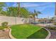 Backyard with a pool, privacy fence, tropical landscaping and green lawn at 5258 E Elena Ave, Mesa, AZ 85206