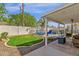 Backyard featuring a pool, grass area, covered patio and desert landscaping at 5258 E Elena Ave, Mesa, AZ 85206