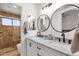 Modern bathroom featuring double vanity with marble countertop and walk-in shower at 5258 E Elena Ave, Mesa, AZ 85206