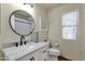 Stylish bathroom features marble countertop, undermount sink, modern black faucet, round mirror, and neutral palette at 5258 E Elena Ave, Mesa, AZ 85206