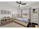 Bedroom with a window view, ceiling fan, decorative artwork and books at 5258 E Elena Ave, Mesa, AZ 85206