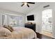 Serene bedroom with a large bay window offering a view, complemented by dark furniture and ensuite bathroom entrance at 5258 E Elena Ave, Mesa, AZ 85206