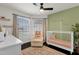 Bedroom with a crib, chair, rug, shelving and a view to the outdoors at 5258 E Elena Ave, Mesa, AZ 85206